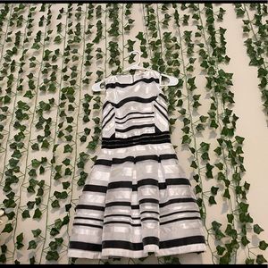 It’s a sleeveless medium black and white dress